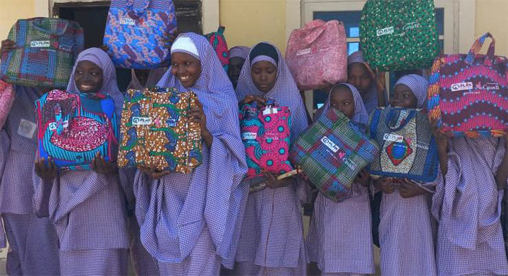 A group of girls receive kits with
period products